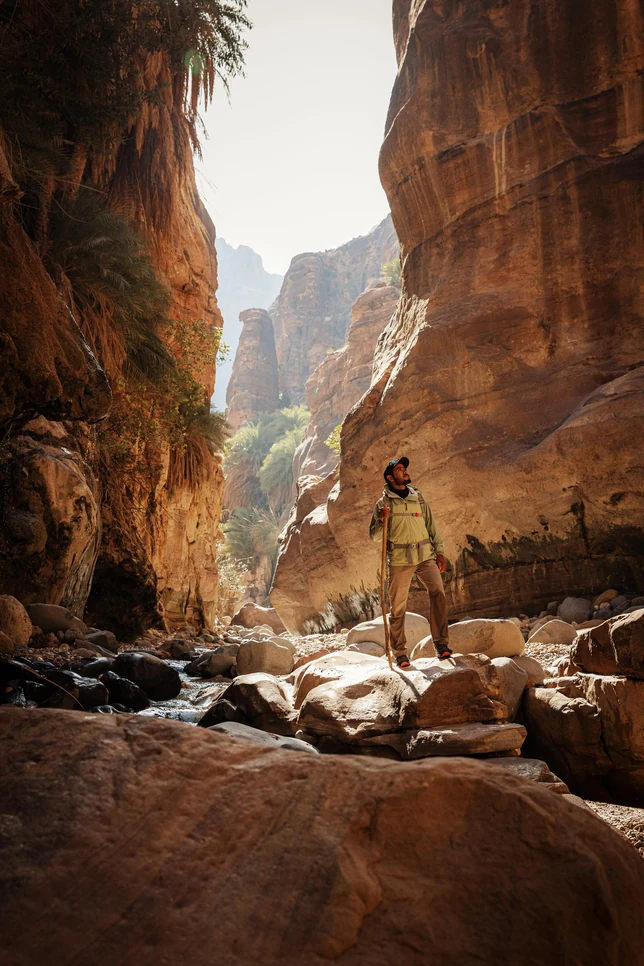 Towering sandstone walls of Wadi Ghwayr Canyon